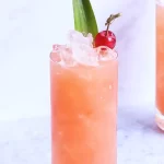 A professionally crafted Manhattan cocktail with a cherry garnish