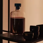 Kit wine making recipes - Bottles of homemade wine with winemaking equipment.