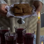 A variety of sweet wines displayed with a backdrop of vineyards.
